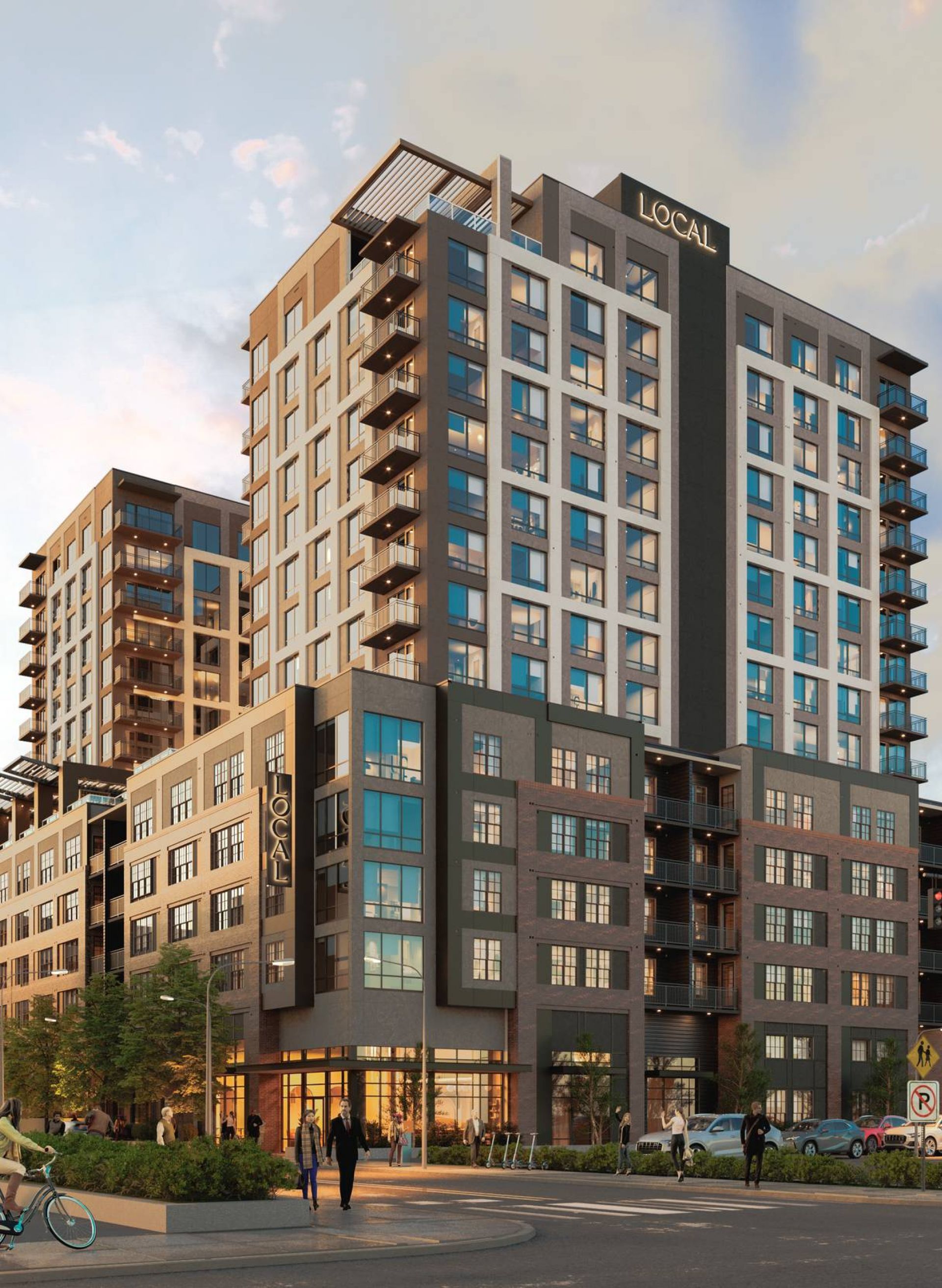 A modern multi-story building with large windows and varying brown hues prominently displaying the "LOCAL Nashville" signage above the main entrance at dusk.